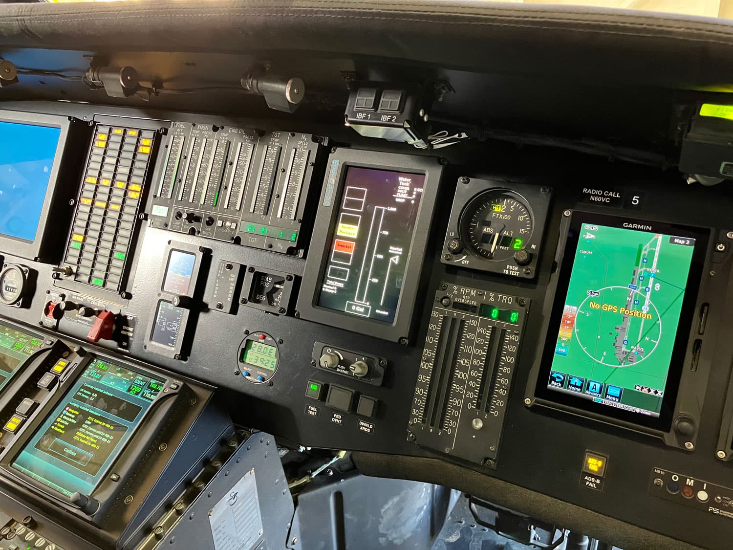 Black Hawk-family helicopter instrument panel, a Macro-Blue display among the engine, navigation and mission instruments across the pedestal