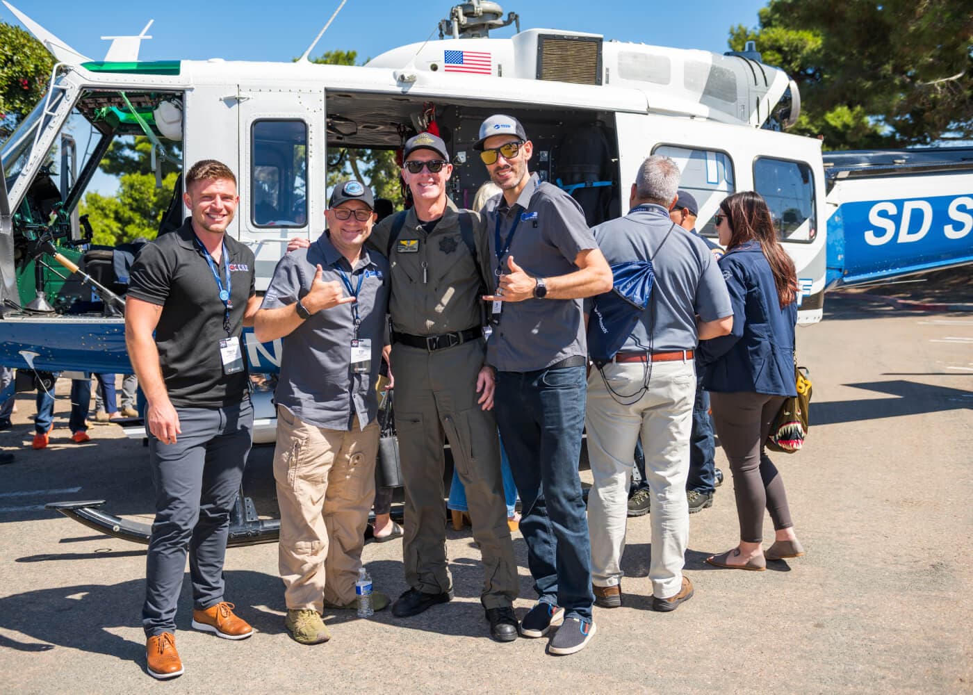 Attendees at the ECHO conference in San Diego beside a San Diego Sheriff's Department helicopter