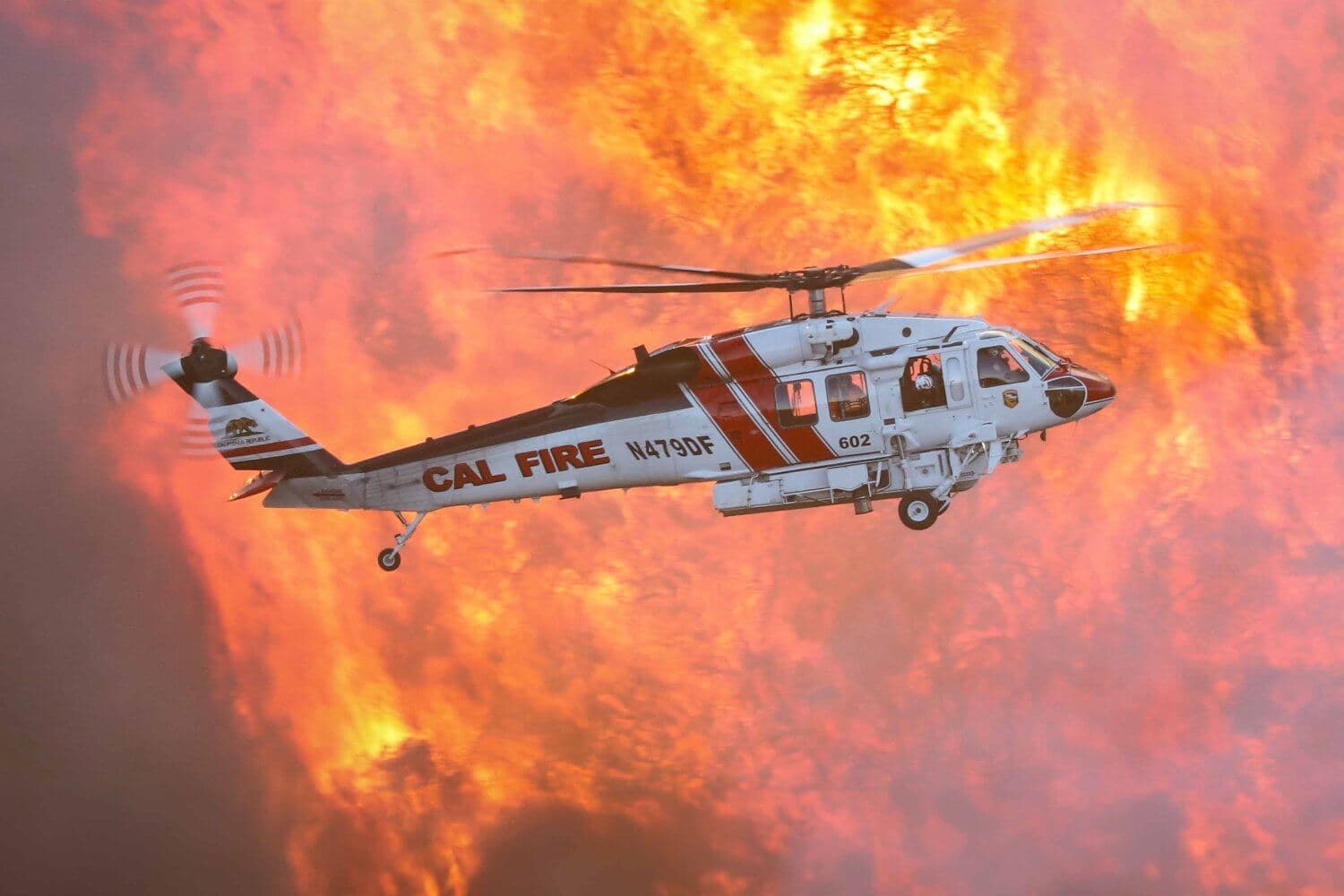 Firefighting helicopter dropping water over the Los Angeles fires