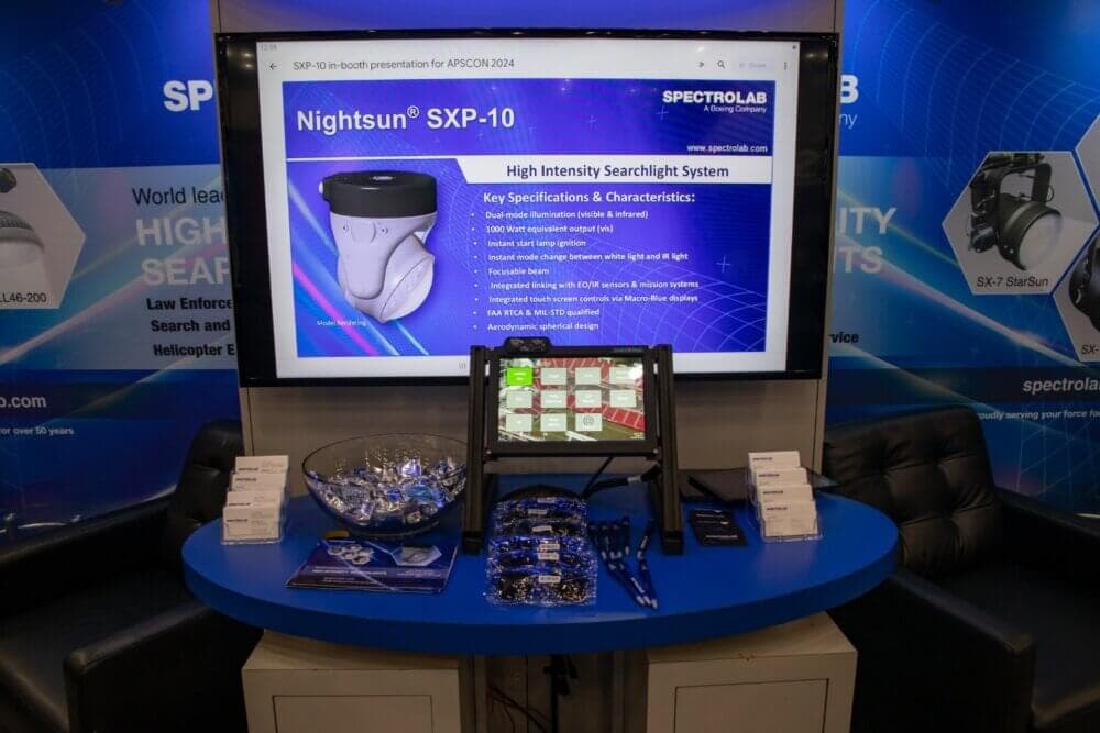 Spectrolab's Nightsun SXP-10 booth presentation, with a Macro-Blue touchscreen running the searchlight controls